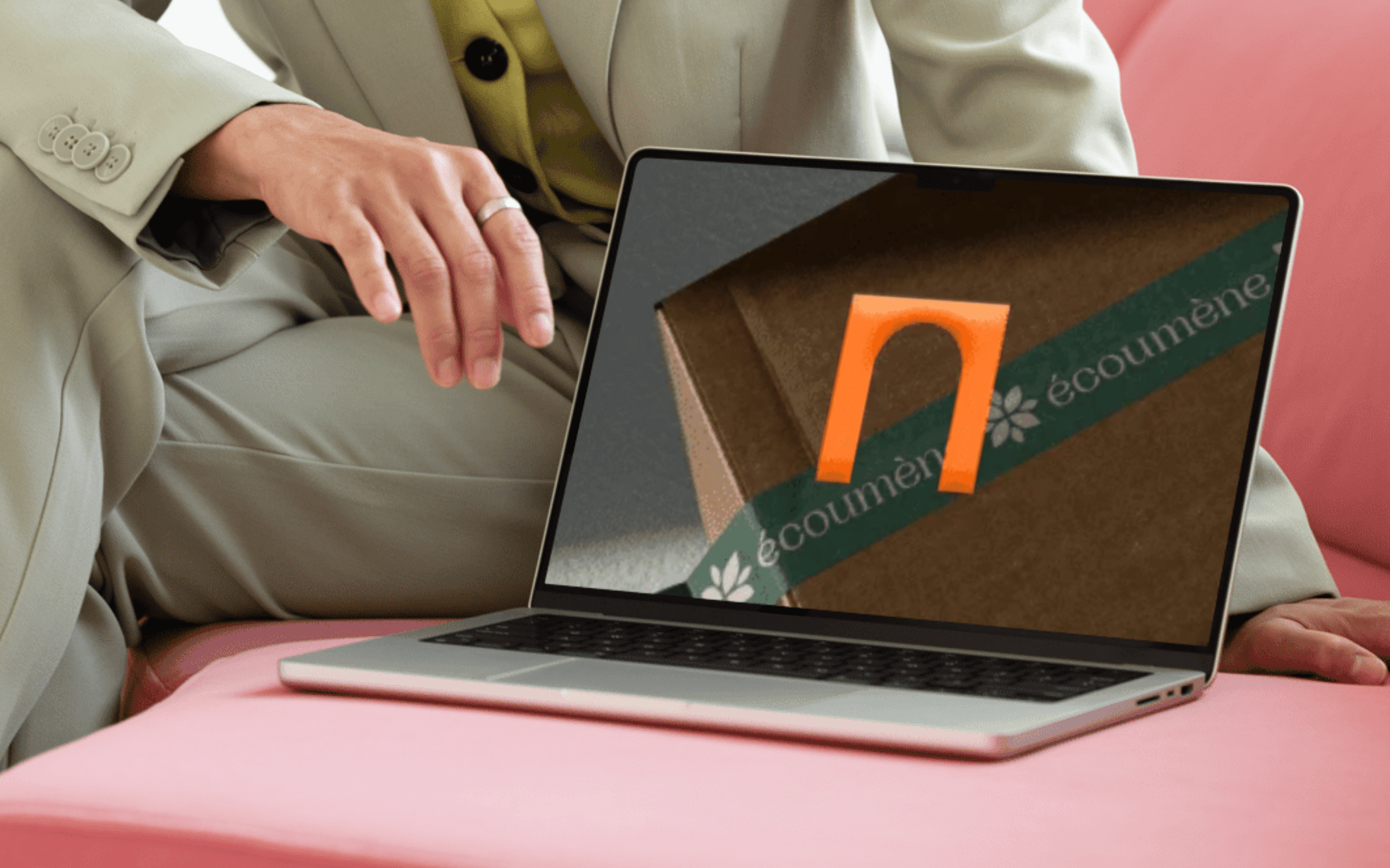Brand logo design displayed on a laptop screen held by a professional