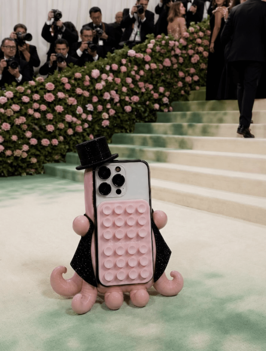 OCTOBUDDY phone grip product dressed in a top hat and cape on the Met Gala carpet, an example of a small brand using cultural moment marketing on social media